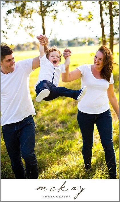 Swinging boy between parents
