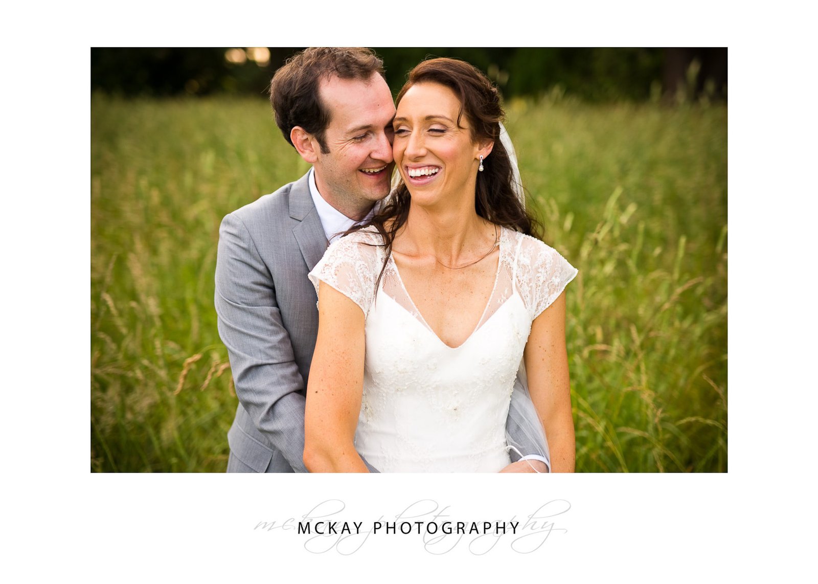 Laughing in grass field wedding Bowral